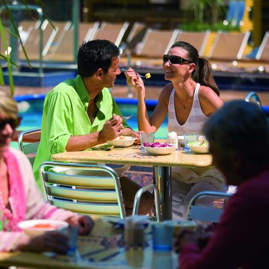 A couple enjoying breakfast on a table outdoors