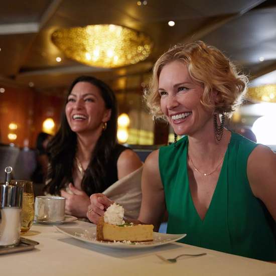 Two women enjoying a dessert at a restaurant