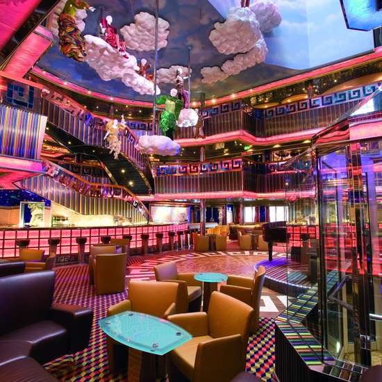 A colourful atrium space with tables and chairs