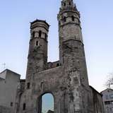 An old grey stone cathedral with two octagonal towers