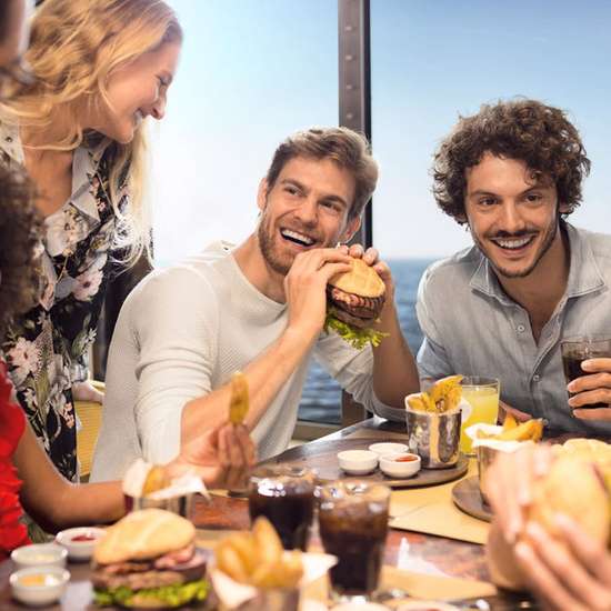 A group of people enjoying burgers and fries