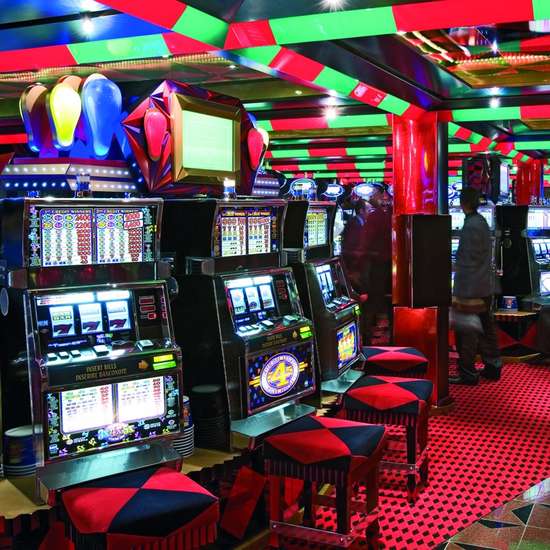 Vegas-style slot machines in a casino with red carpets