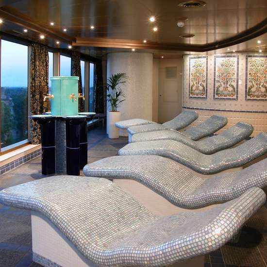 Several heated loungers in a large room with tall windows