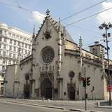 A white-stone church in Lyon, with an eight-story building behind it