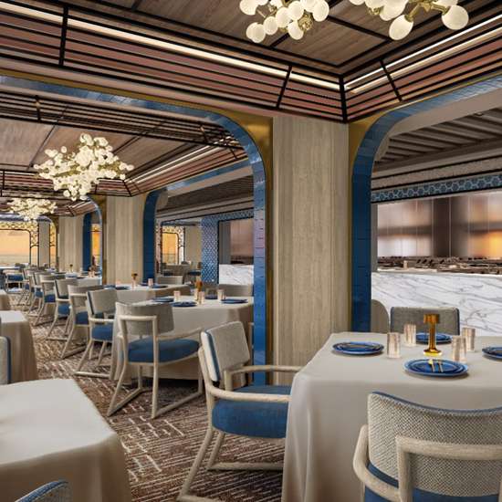 The interior of a stylish restaurant with blue and white table decor and light brown carpets