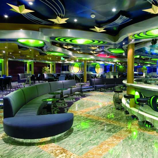 A green-themed bar with sofas and stools 