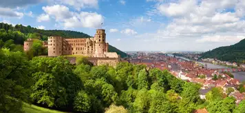 Image related to Medieval castle ruins surrounded by trees on a hilltop