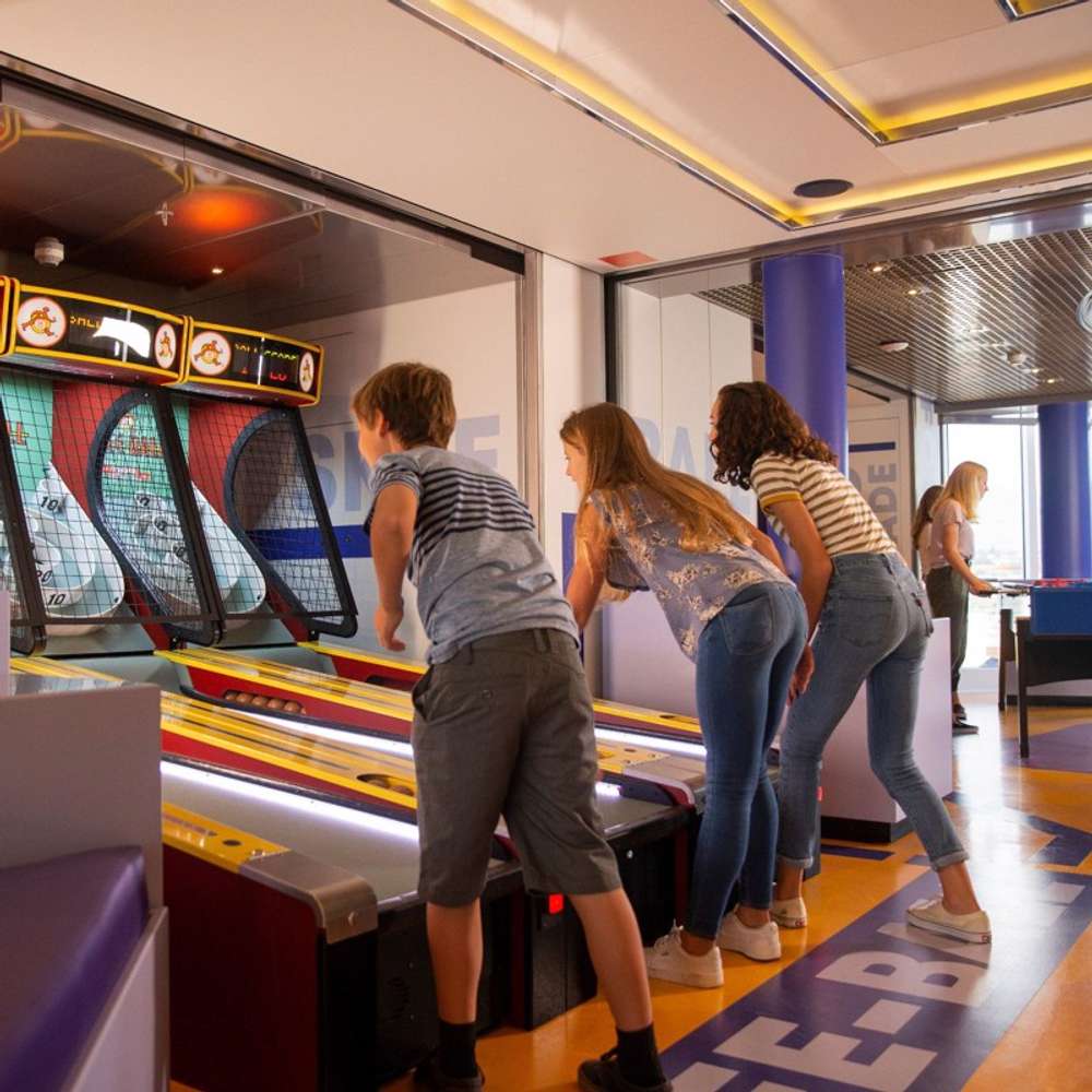Three kids playing Skee-Ball in High Score