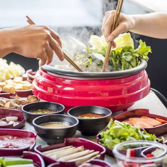 An image of people eating Shabu Shabu, a Japanese hotpot dish