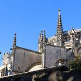 Part of a gothic-style cathedral with a bright blue sky background