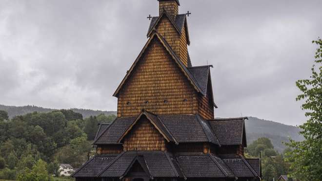 Discover a charming Sognefjord village famed for its ancient stave church and mountain backdrop.