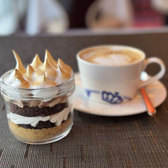 An image of a small s'mores cake and a coffee 