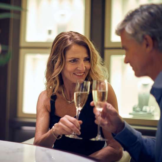 Two people enjoying a glass of champagne in a stylish lounge