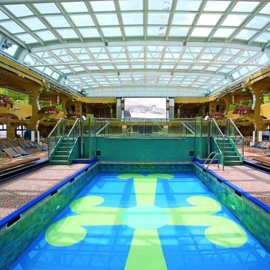 A swimming pool with a cross design tiled in the bottom