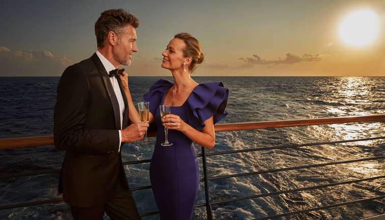 A couple on deck as the sun sets