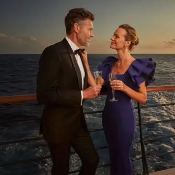 A couple on deck as the sun sets
