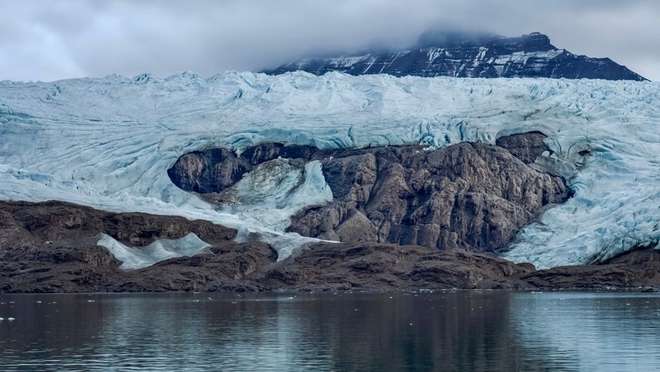 Sail to a remote volcanic island crowned by the world's northernmost active volcano.