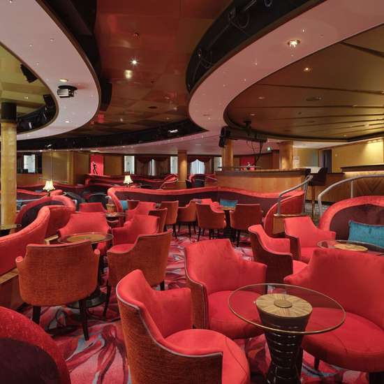 Red-themed lounge seating in a theatre venue