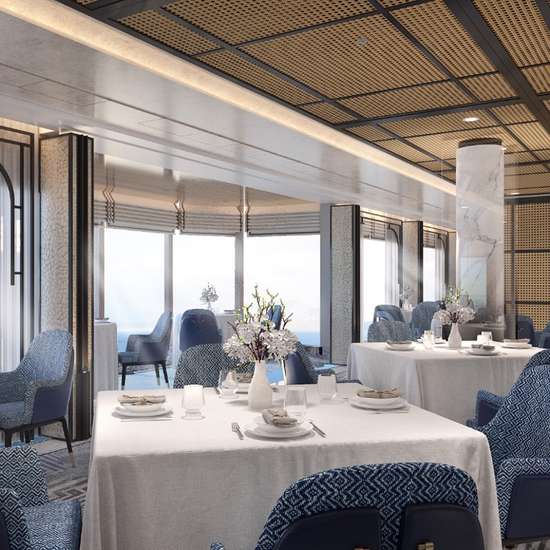 A bright restaurant interior with blue chairs and white décor