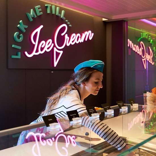 A woman serving ice cream at a counter