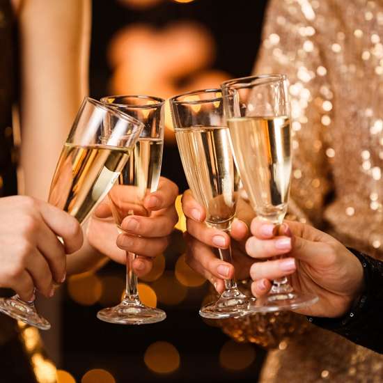 People clinking champagne glasses