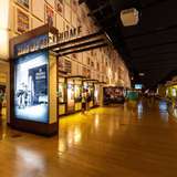 A museum interior with illuminated displays along a long wall